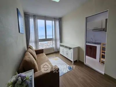 Cozy living room with a stunning view and adjacent compact kitchen