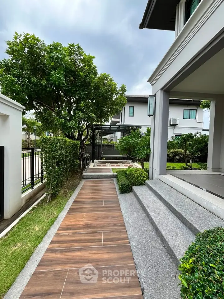 Elegant modern home exterior with lush garden and stylish walkway