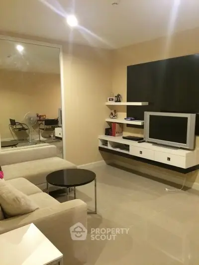 Modern living room with sleek TV setup and cozy seating area
