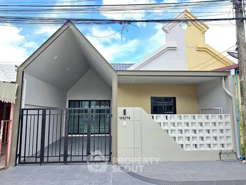 Modern single-story house with unique architectural design and spacious driveway.
