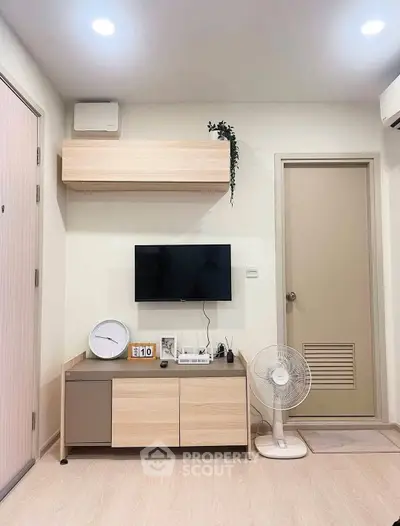 Modern living room with minimalist decor and wall-mounted TV