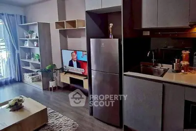 Modern open-plan living room with sleek kitchen and stylish decor