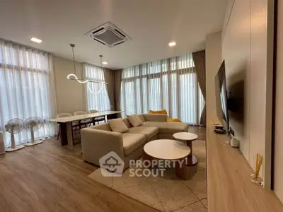 Spacious modern living room with elegant decor and large windows for natural light.