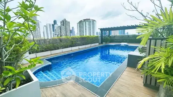 Luxurious rooftop pool with stunning city skyline views, perfect for relaxation and leisure in a modern urban setting.