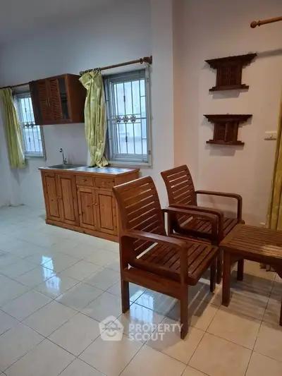 Charming interior with wooden furniture and natural light, perfect for cozy living.