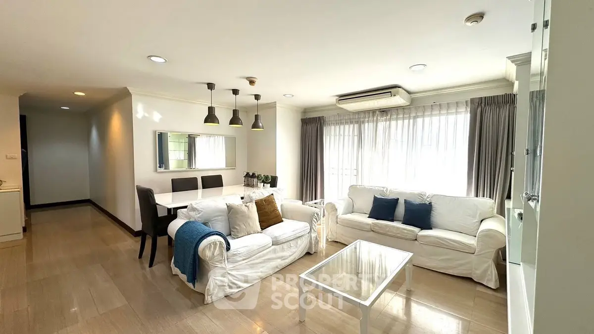Spacious living room with elegant decor and ample natural light