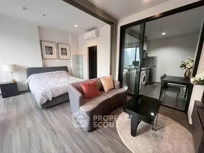 Modern studio apartment with stylish decor and open layout, featuring a cozy living area and sleek kitchen.