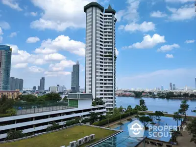 Stunning riverside high-rise building with panoramic city views and lush gardens.