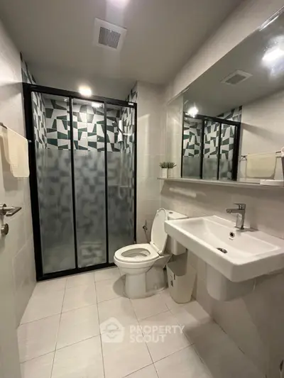 Modern bathroom with geometric shower design and sleek fixtures