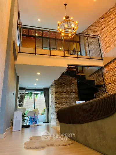 Stunning loft apartment with modern chandelier and exposed brick walls