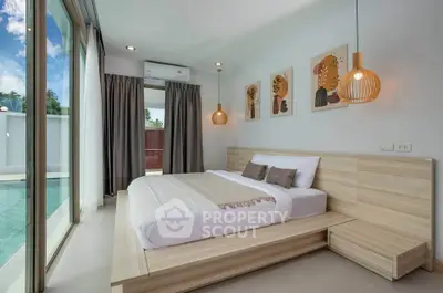 Luxurious bedroom with pool view, modern decor, and natural light in a serene setting.