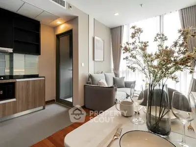 Modern apartment interior with stylish kitchen and cozy living area, featuring elegant decor and natural light.