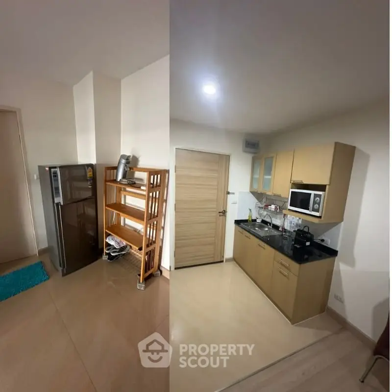 Modern kitchen with sleek cabinets and appliances in a cozy apartment setting.