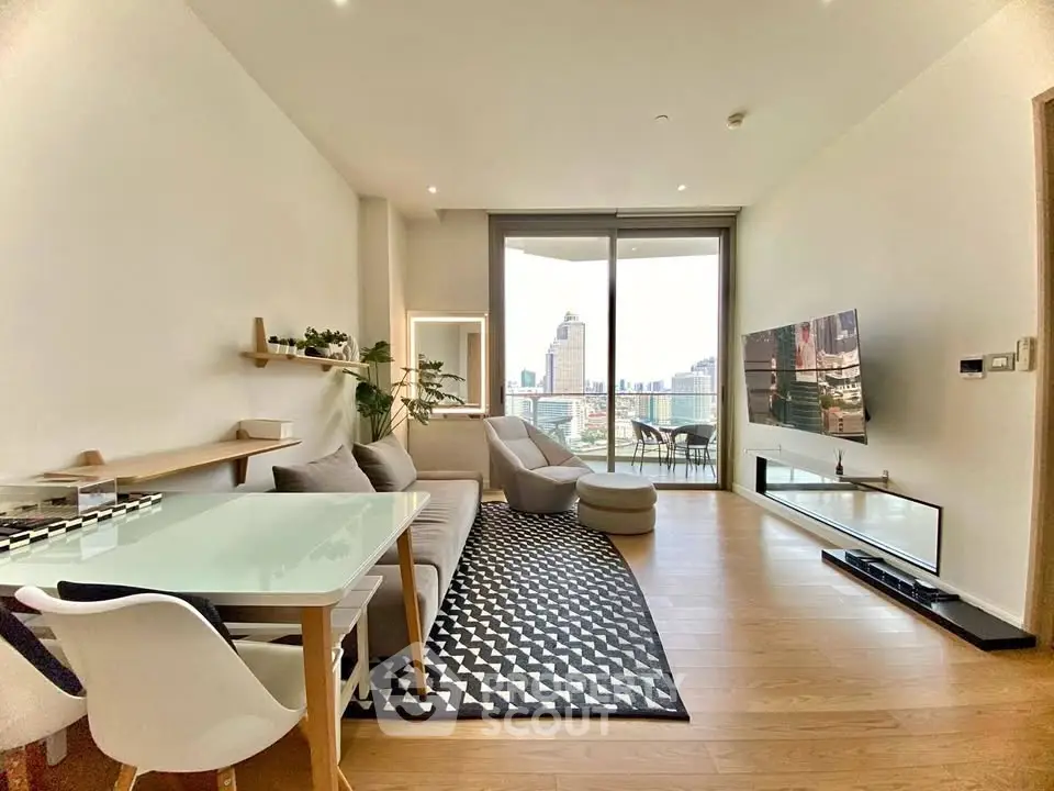 Modern living room with city view, stylish furniture, and large TV in a high-rise apartment.