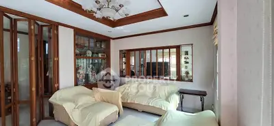 Spacious living room with elegant wooden accents and cozy seating area