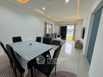 Spacious modern living room with elegant dining area and stylish furniture.