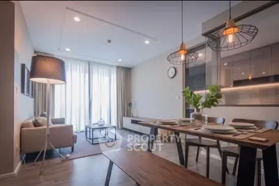 Modern living room with dining area and stylish lighting in a cozy apartment.