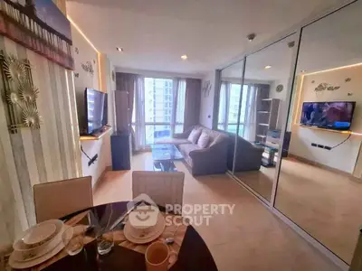 Spacious living room with modern decor and large windows offering city views.