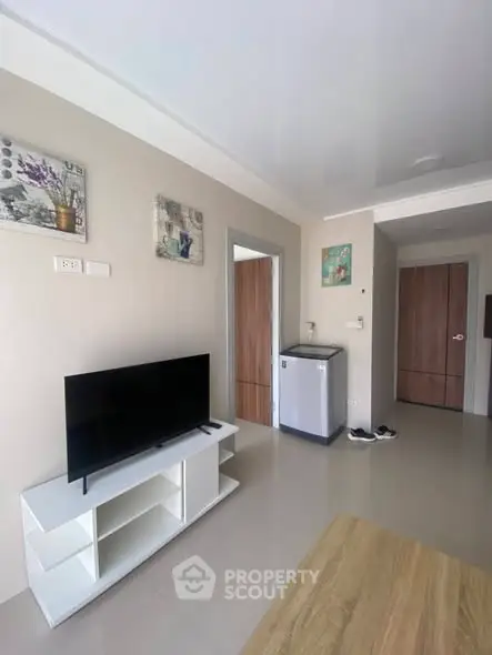 Modern living room with sleek TV stand and minimalist decor in a cozy apartment.