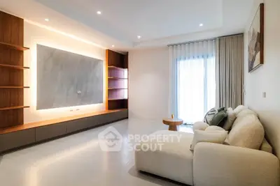 Spacious modern living room with elegant lighting and cozy seating area.