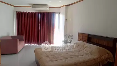 Spacious bedroom with natural light and modern furnishings