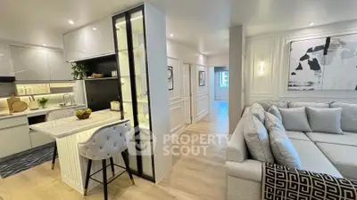 Luxurious open-plan living room and kitchen with modern decor and elegant furnishings.