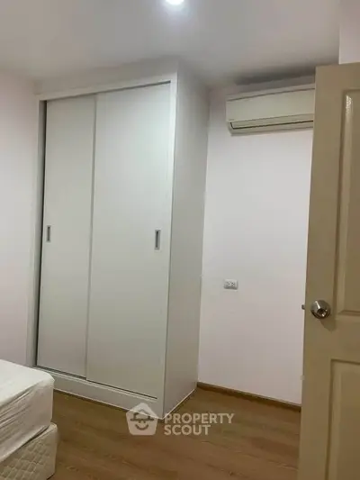 Cozy bedroom with built-in wardrobe and air conditioning, perfect for comfortable living.