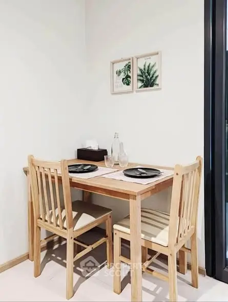 Cozy dining nook with wooden table and chairs, perfect for intimate meals.
