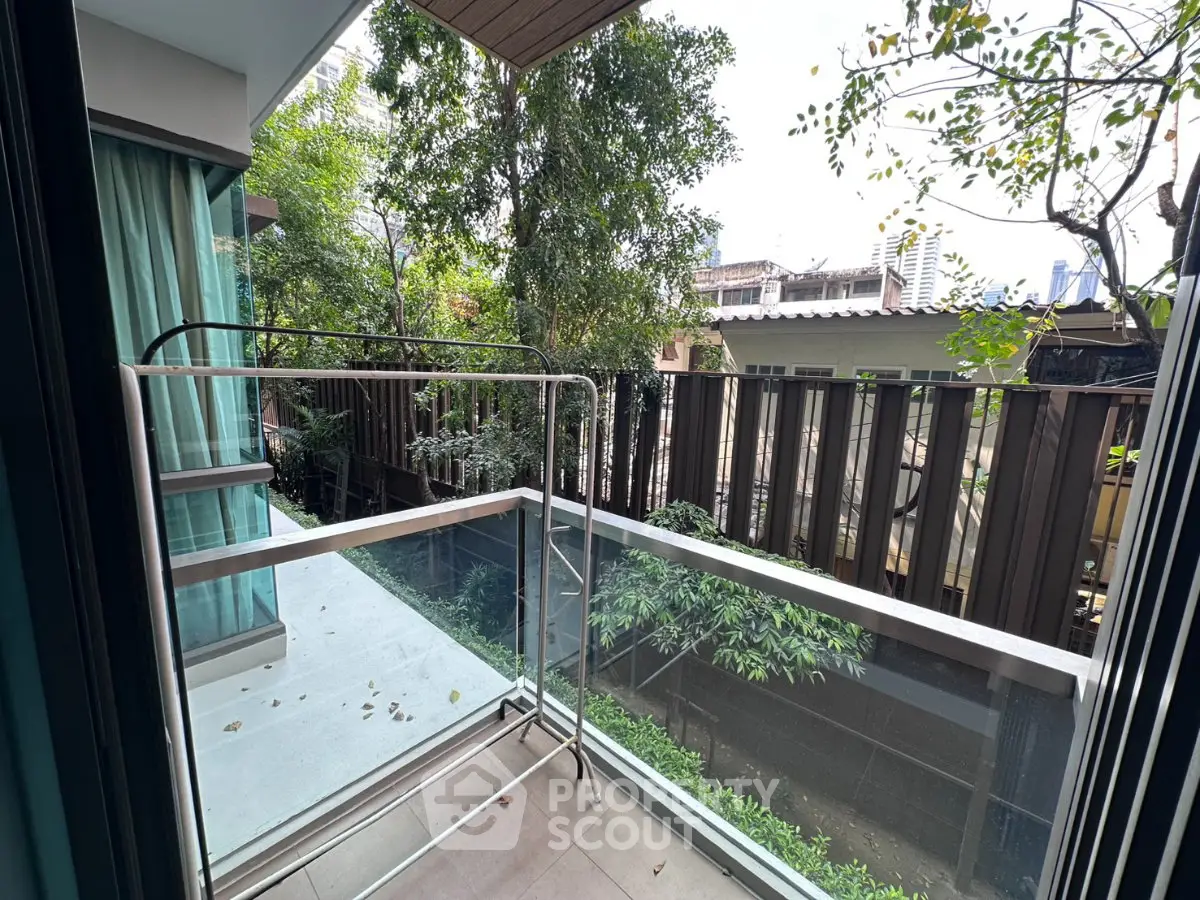 Charming balcony with lush greenery view in modern apartment