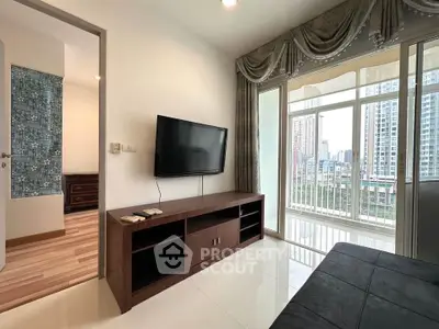 Modern living room with city view, sleek TV setup, and elegant curtains in a high-rise apartment.