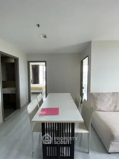 Modern apartment interior with dining table and neutral decor