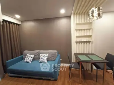 Modern living room with stylish blue sofa and elegant dining area