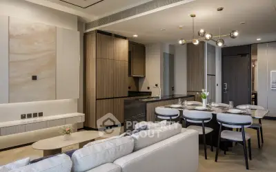 Luxurious open-plan living room and kitchen with modern decor and elegant dining area.