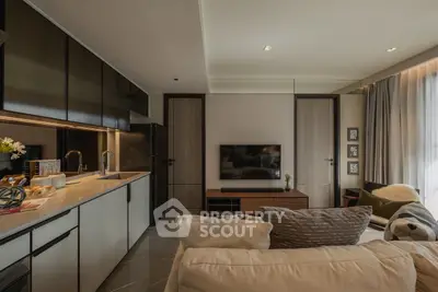 Modern open-layout living room with sleek kitchen and cozy seating area