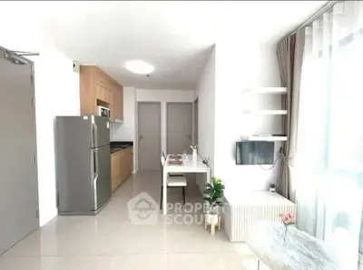 Modern kitchen and dining area with sleek design and natural light