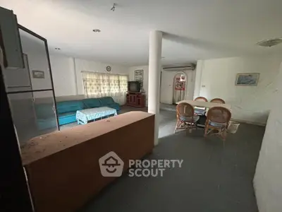Spacious living and dining area with natural light and cozy furnishings.