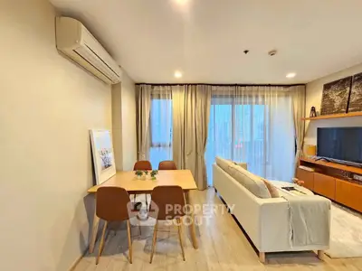 Modern living room with dining area and large window view