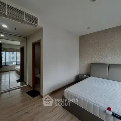 Modern bedroom with mirrored closet and stylish wallpaper