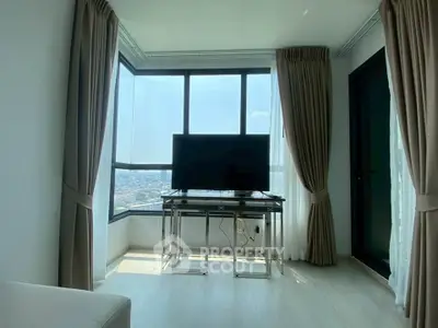 Bright living room with large windows offering stunning city views and modern decor.