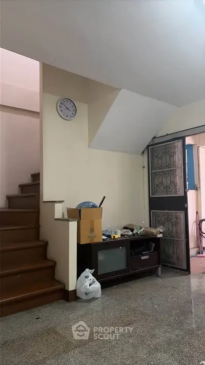 Cozy interior with staircase and TV unit, ideal for small family living.