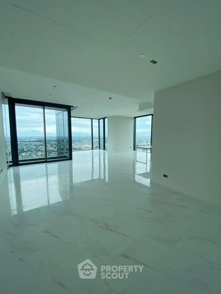 Spacious modern living room with panoramic city views and large windows.