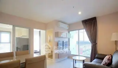 Modern living room with dining area and balcony access in a stylish apartment.