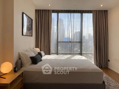 Luxurious bedroom with city view, modern decor, and natural light