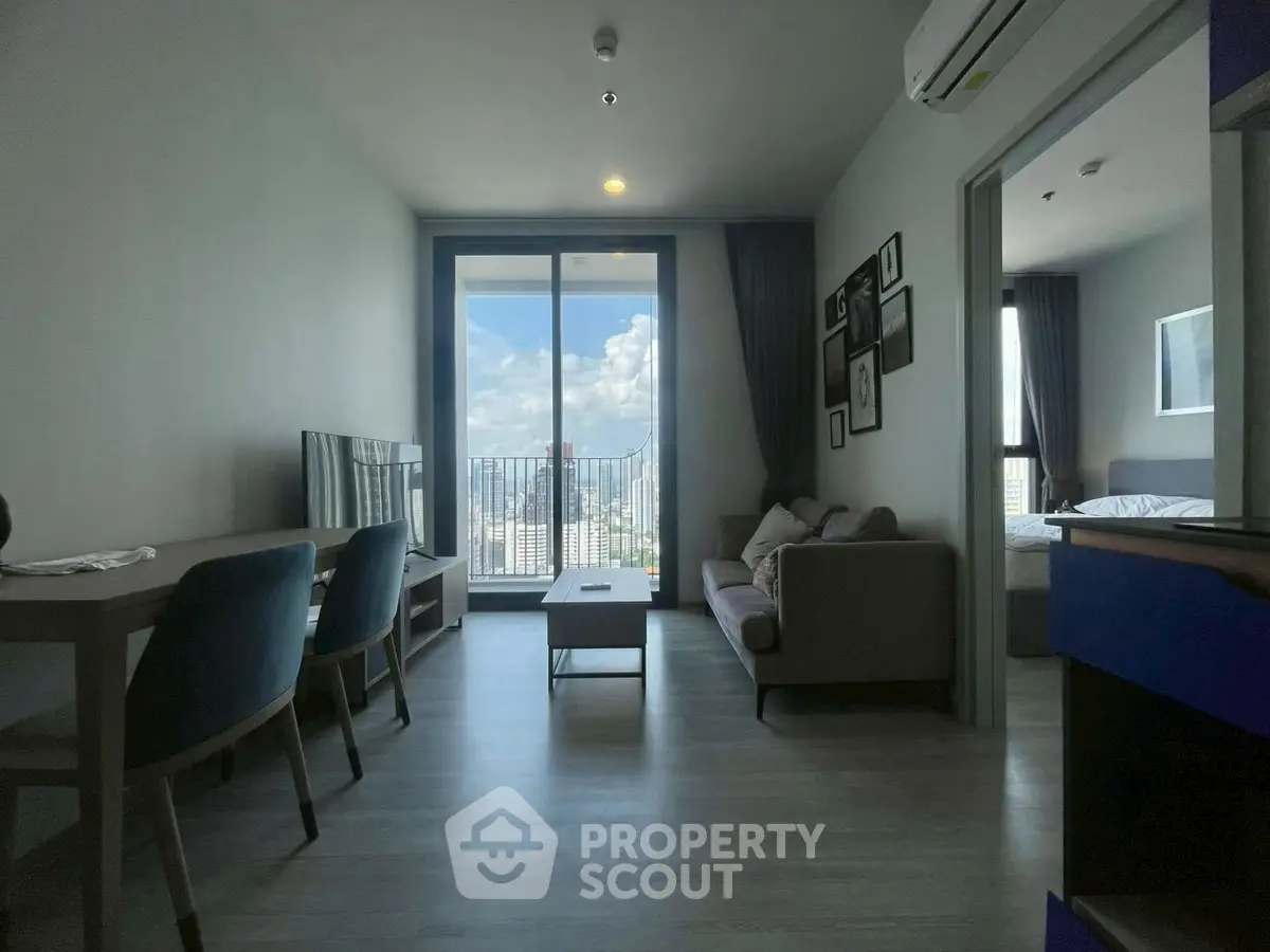Modern living room with stunning city view, stylish furniture, and large windows for natural light.