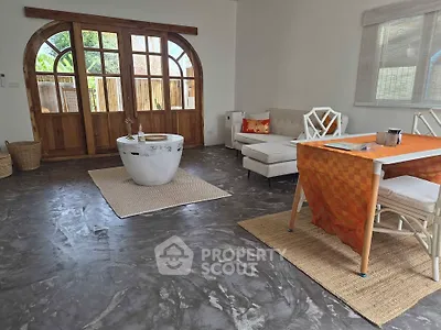 Spacious living room with stylish flooring and elegant wooden doors
