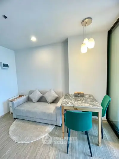 Modern living room with cozy sofa and stylish dining area in a bright apartment.