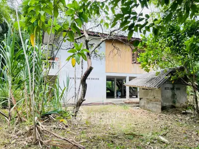 Charming rustic house surrounded by lush greenery, perfect for nature lovers seeking tranquility.