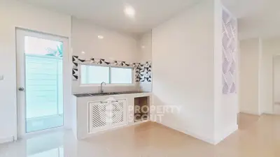 Modern kitchen with sleek design and geometric backsplash in a bright interior space.