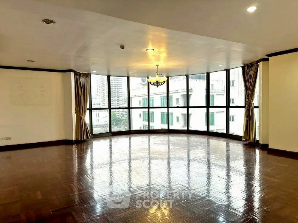 Spacious living room with panoramic windows and city view