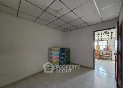 Spacious room with tiled floor and storage drawers, ideal for customization.